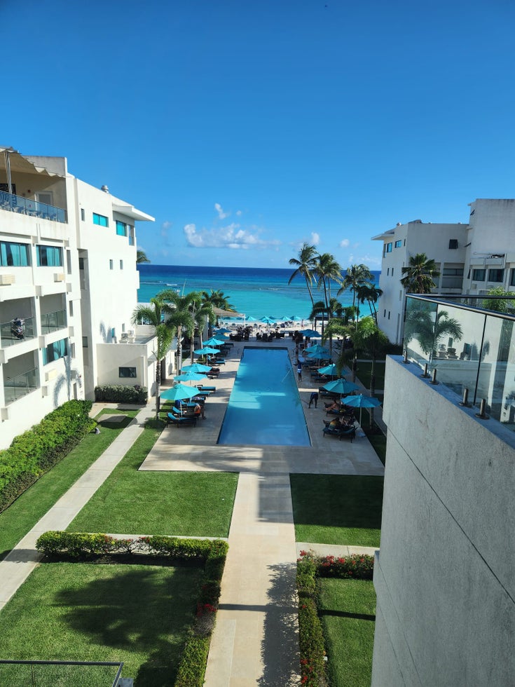 View from patio overlooking pool area and out to sea