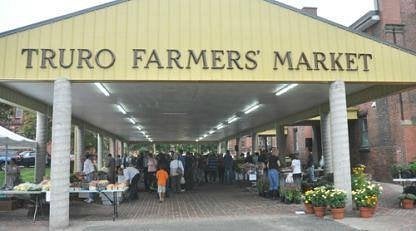 Entrance to the Truro Farmers’ Market with local vendors and visitors browsing fresh goods