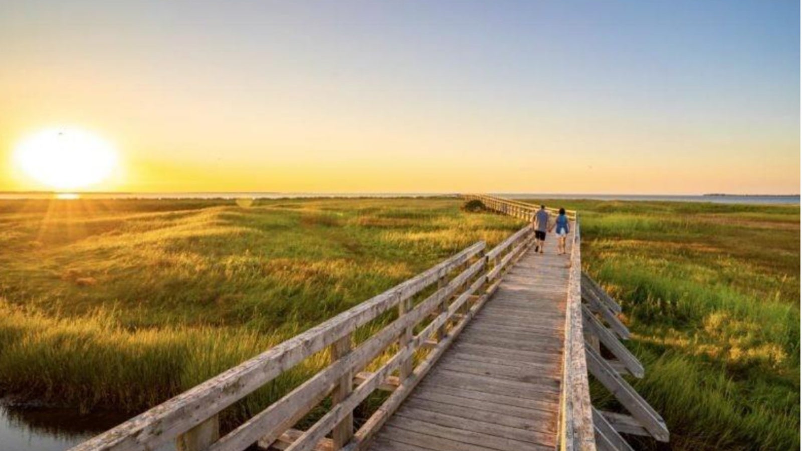 Waterfront boardwalk at sunset