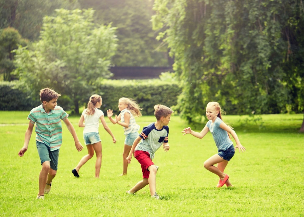 Family Life in Crichton Park Dartmouth Parks and Outdoor Play Children playing together in a grassy park in Crichton Park Dartmouth highlighting family-friendly neighbourhood living and outdoor space