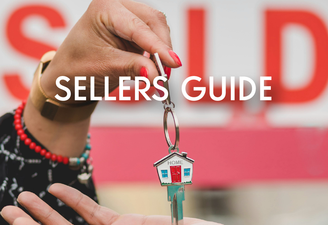 a hand with painted red nails dropping keys into another hand