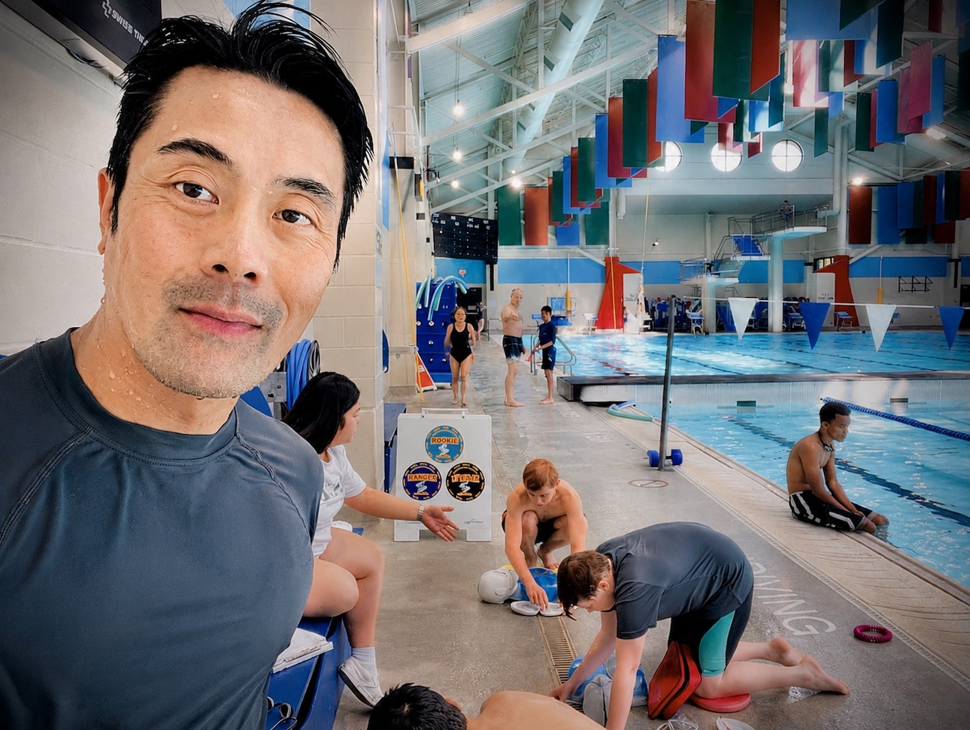 Wilson Chiu participating in Bronze Medallion lifesaving training at an indoor pool, developing rescue and water safety skills.
