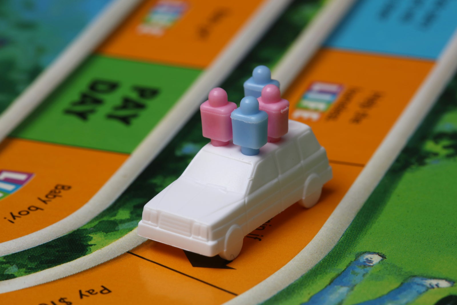 oy car from the Game of Life representing a large purchase that could negatively impact mortgage approval during the home buying process