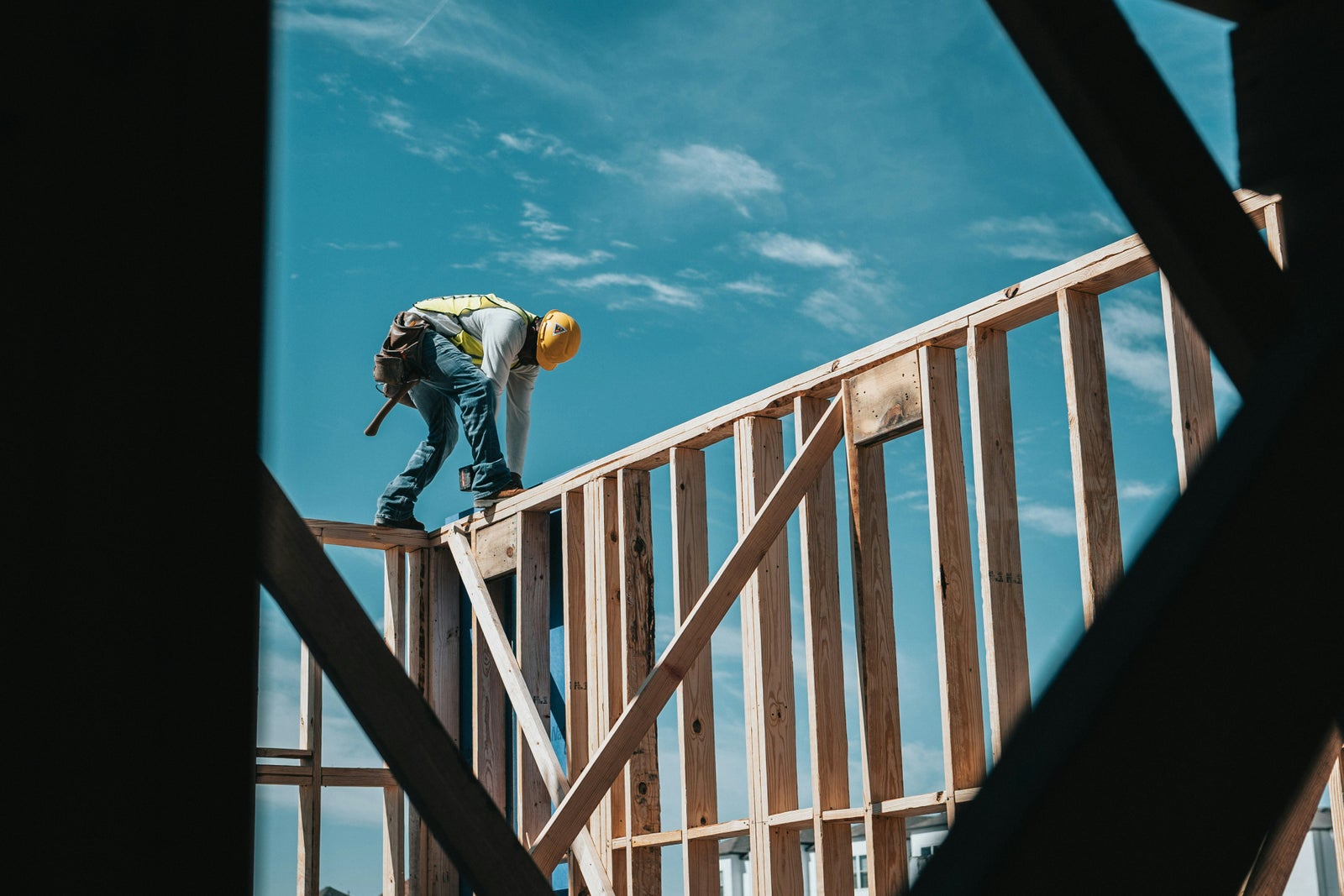 Construction worker framing a new home, illustrating residential development and housing supply in Canada.