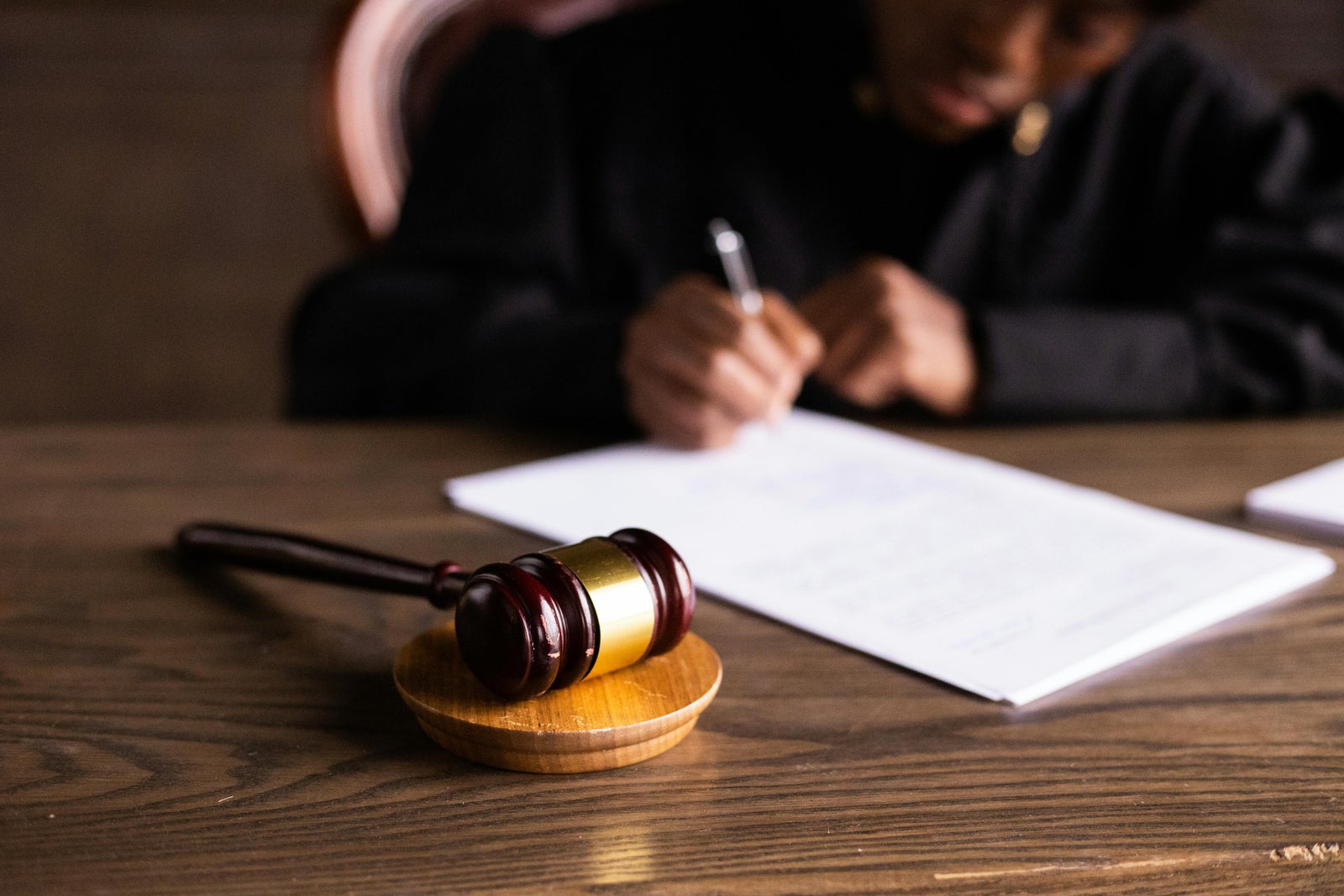 Judge’s gavel on a desk with legal documents being signed representing a lawsuit affecting the Property Disclosure Statement in BC.