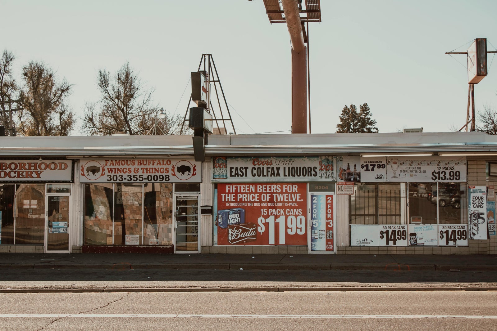 Storefront with price signs representing how asking price and selling price can differ in a market.