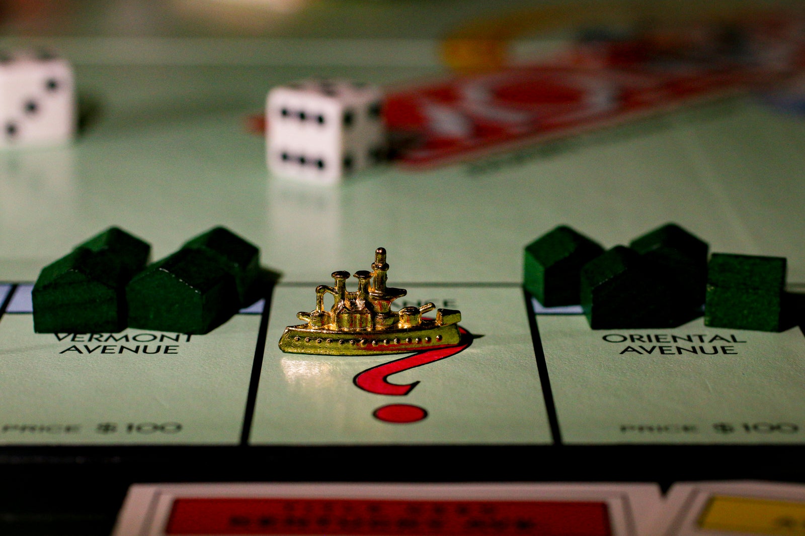 Monopoly ship on a question mark space representing uncertainty in deciding whether to buy or sell first.