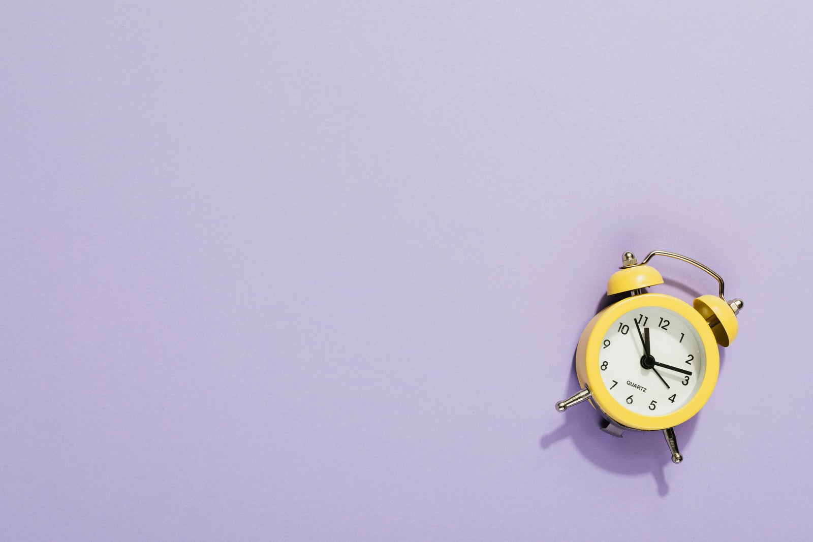Yellow alarm clock representing timing the real estate market in Greater Vancouver.