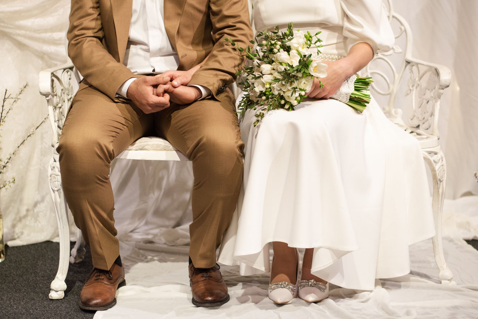 Newlywed couple holding a bouquet, illustrating the concept of marrying