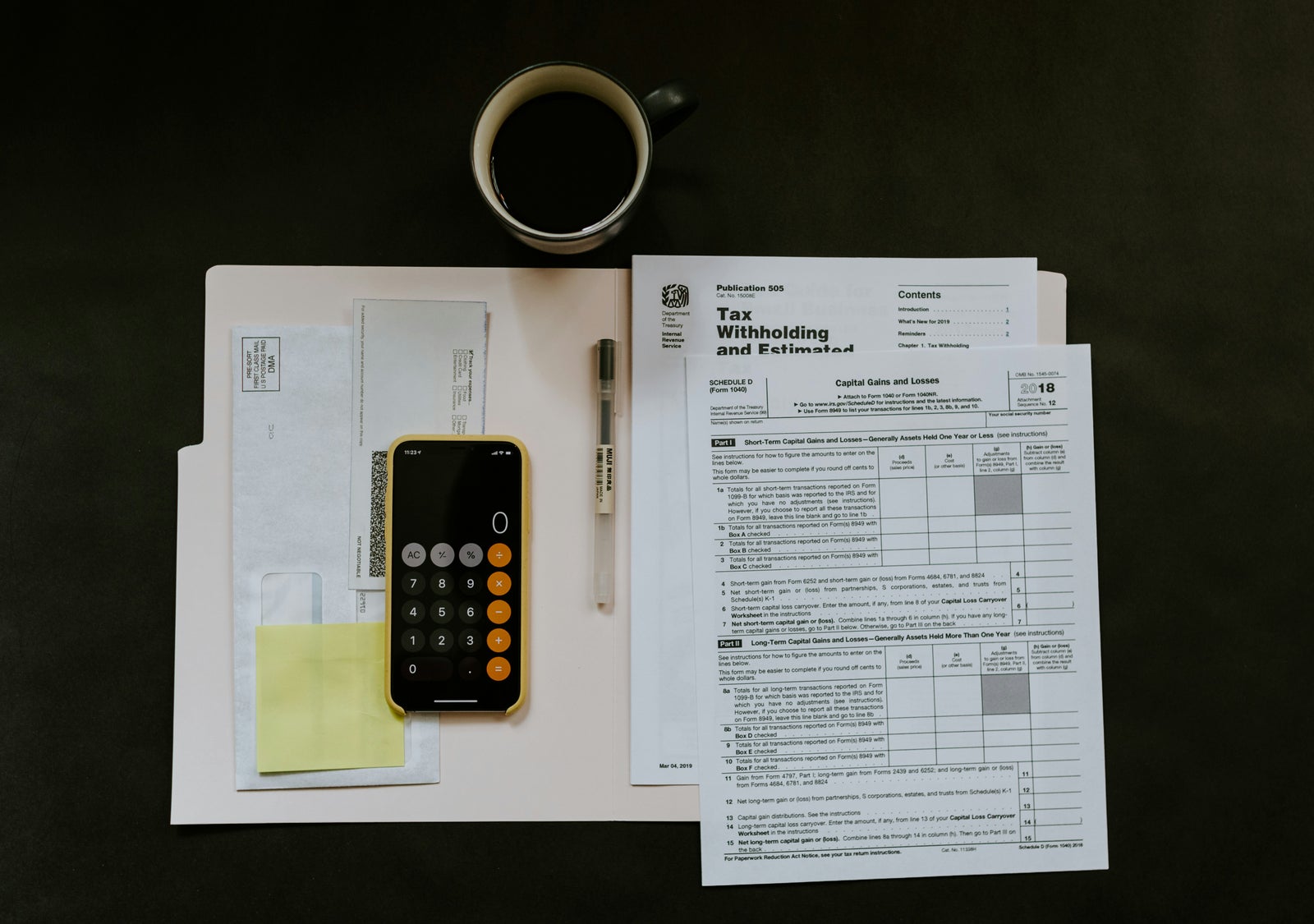Tax forms, calculator, and financial documents representing property transfer tax and other closing costs when buying a home.