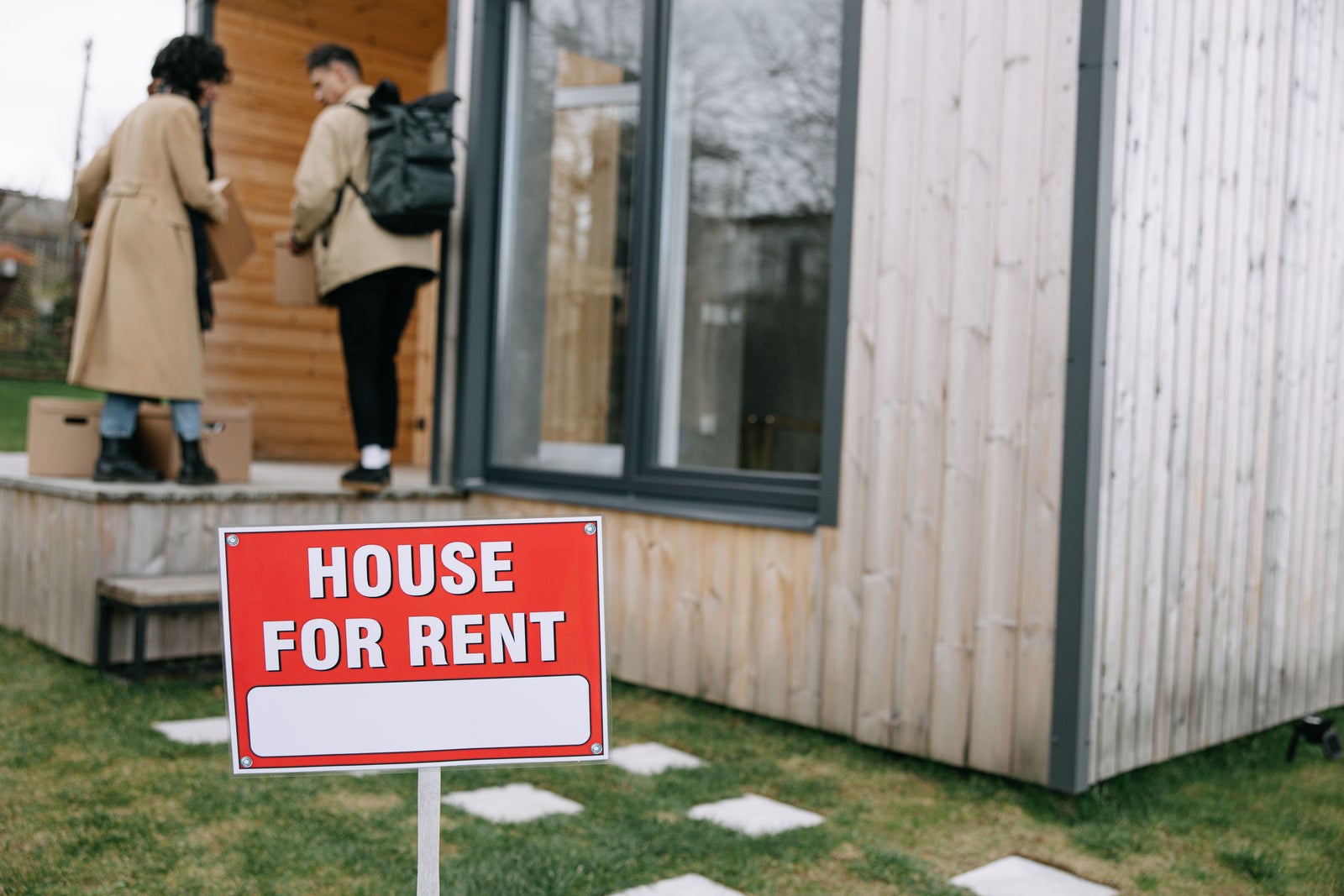 House for rent sign outside a residential property, illustrating the renting side of the rent versus buy decision.