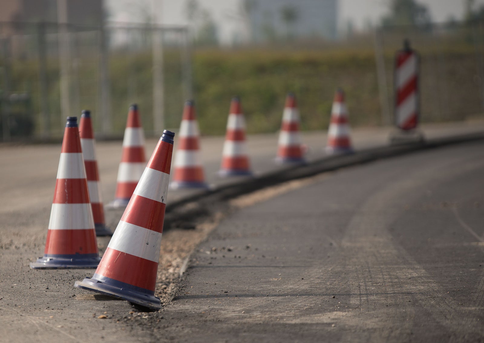 Road construction with traffic cones illustrating municipal infrastructure costs tied to new housing development.