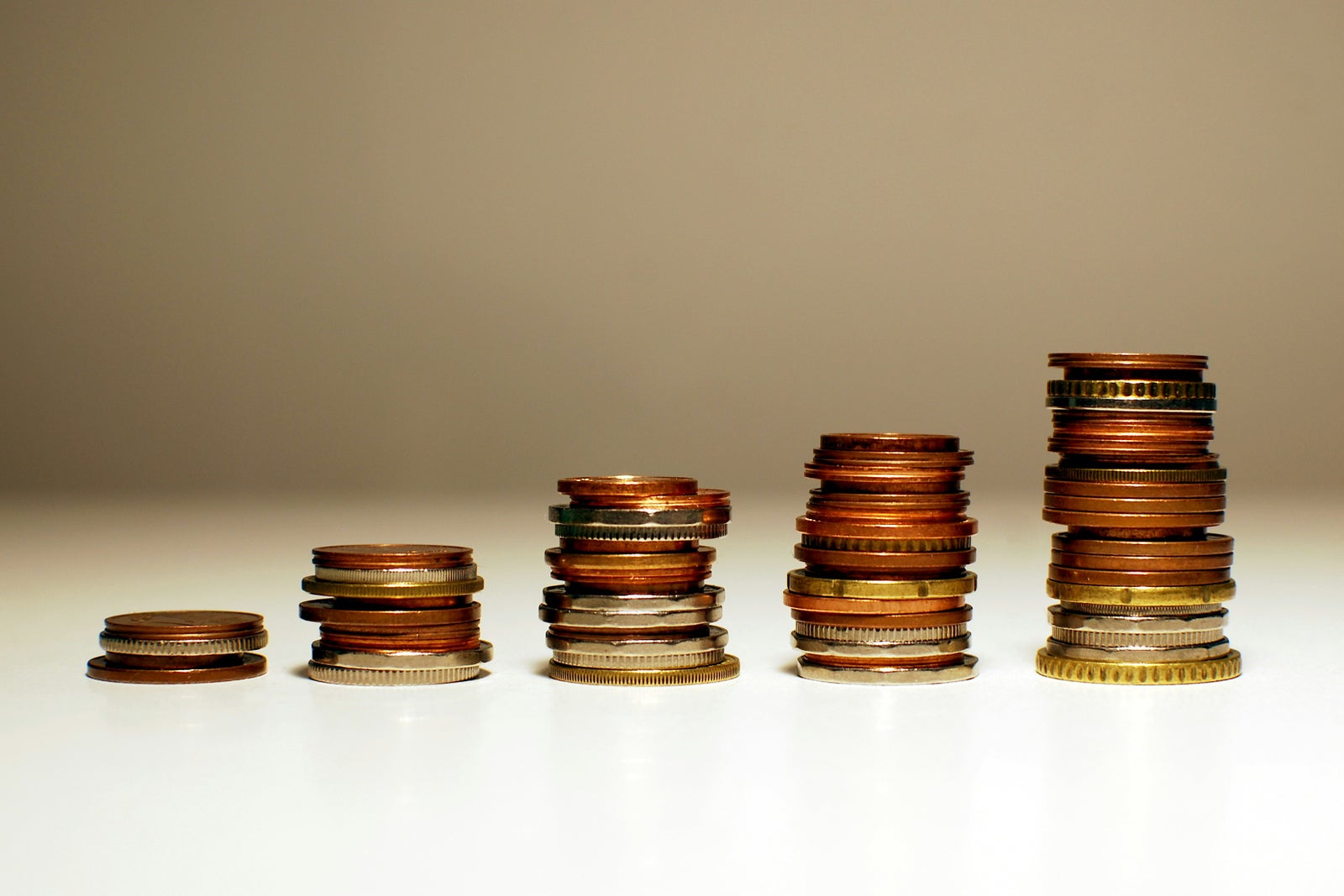 Stacks of coins representing changes in home values over time and the difference between BC Assessment and market value.