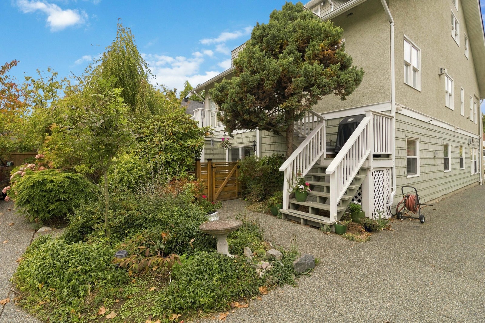 Established gardens and birdbath beside the 1921 character conversion at 1353 Grant Street, Fernwood