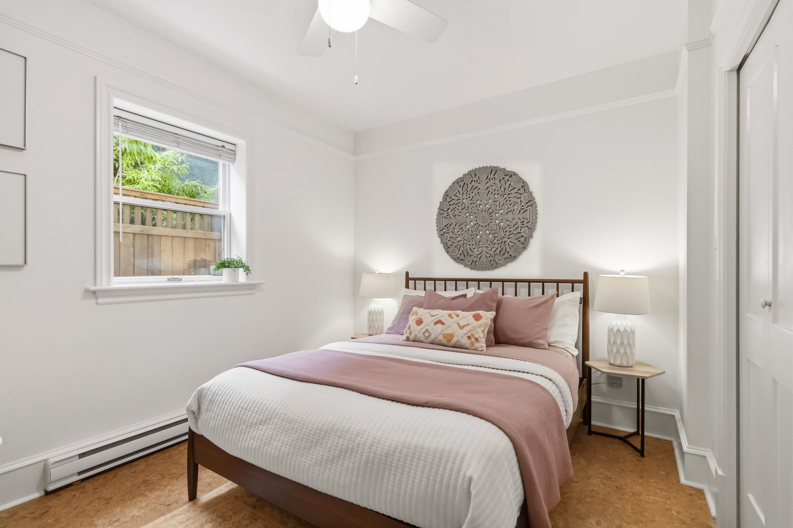 Primary bedroom on the main floor with ceiling fan and double closet in a Fernwood character townhouse