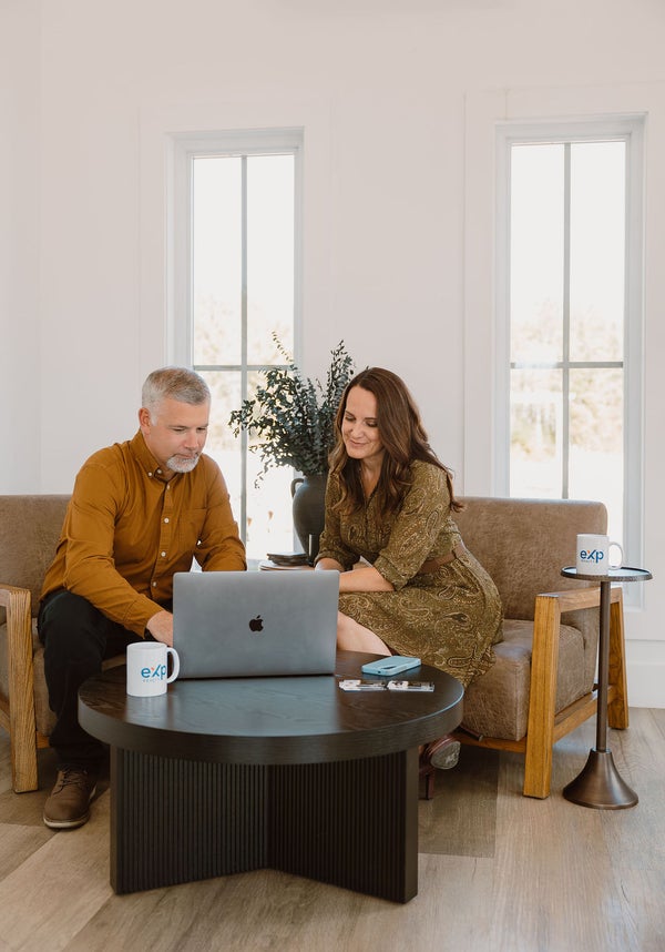 Denise and Marc, REALTORS® in Moncton, New Brunswick, working together in a modern living room setting