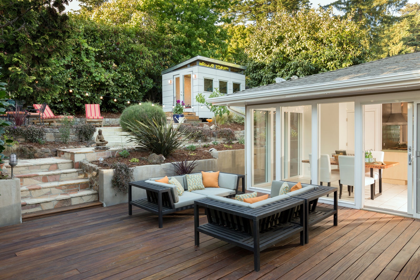 West Coast home with a landscaped garden and outdoor living area