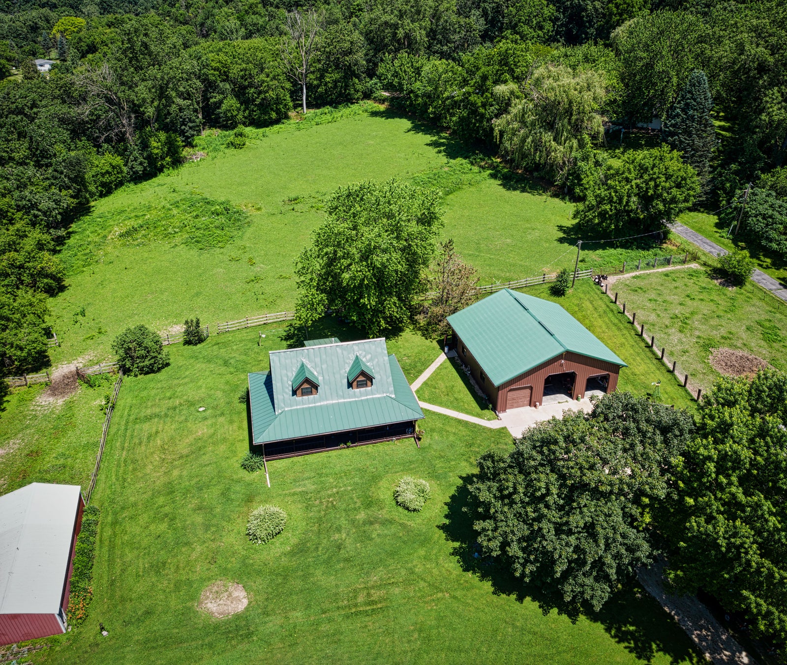 Rural acreage with a home, detached shop, fenced land and mature trees
