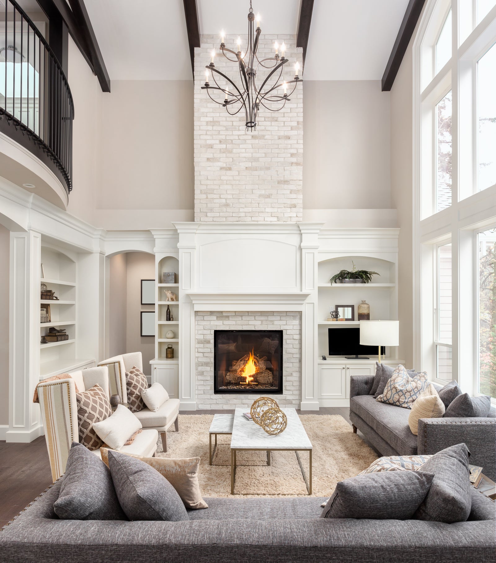 Bright professionally presented living room with fireplace and large windows