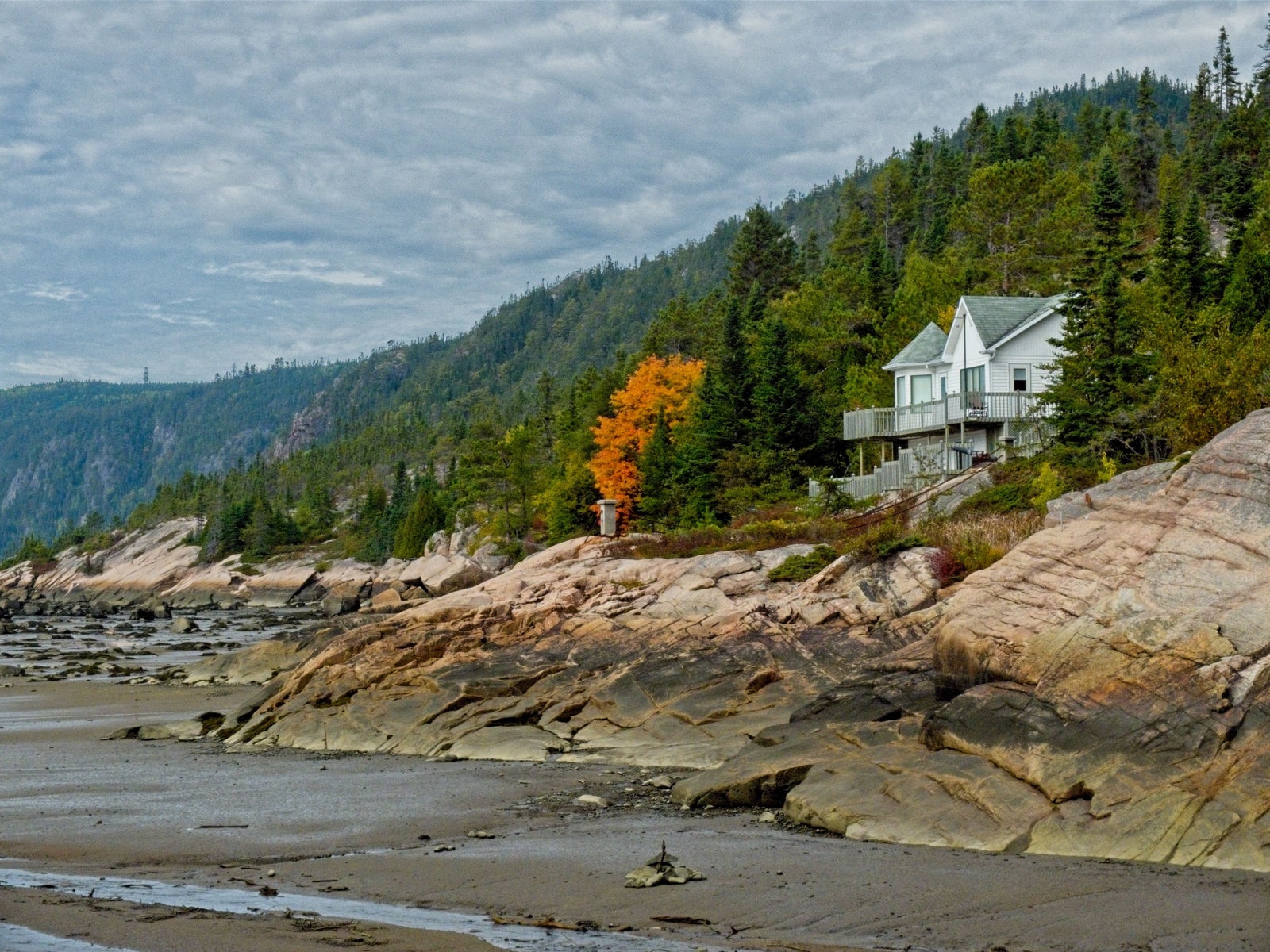 Coastal home above a rocky shoreline