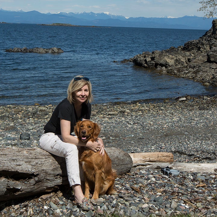 Denise Hodgins with her dog Tio on the Vancouver Island coastline