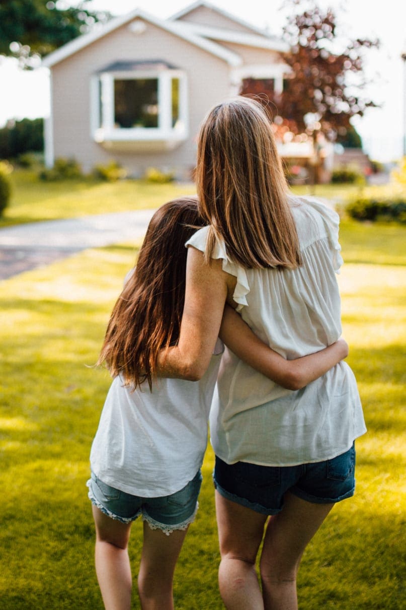 Mother and daughter looking at their home