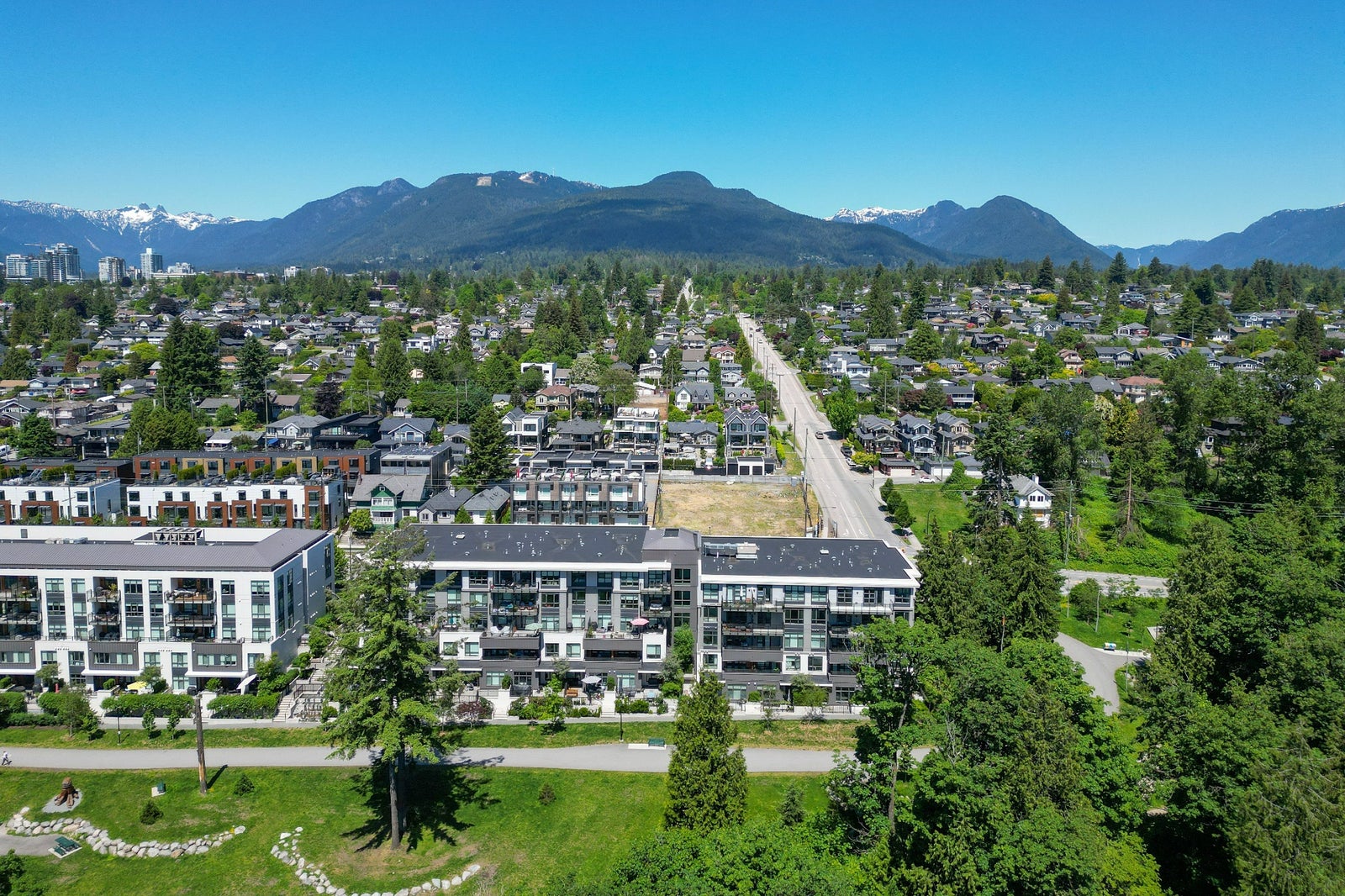 Aerial view of North Vancouver homes, parks and the North Shore mountains