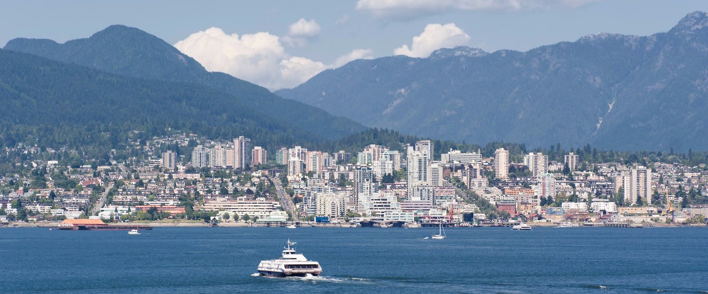 Scenic view of Lower Lonsdale's waterfront and skyline with mountains in the background, highlighting the appeal of Lower Lonsdale real estate