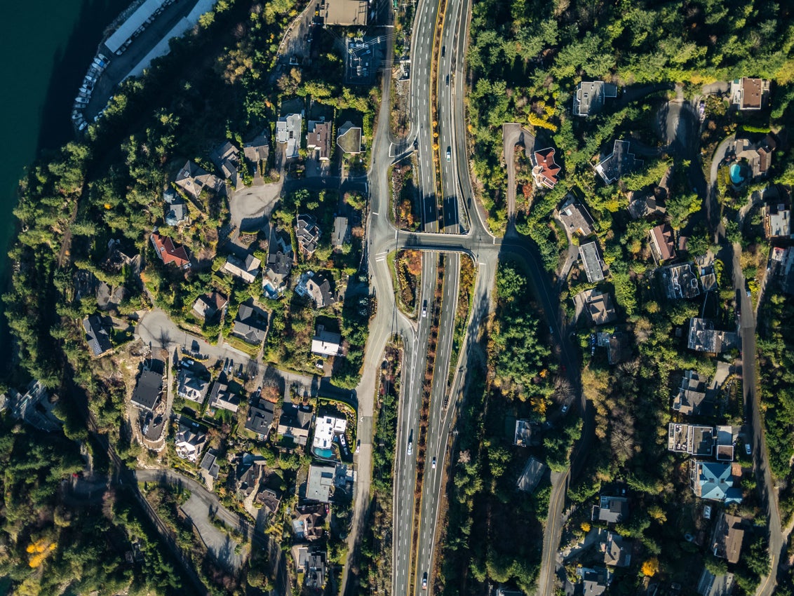 Aerial view of Lions Bay neighbourhood with residential homes nestled among lush forests and near the waterfront, showcasing exclusive real estate opportunities