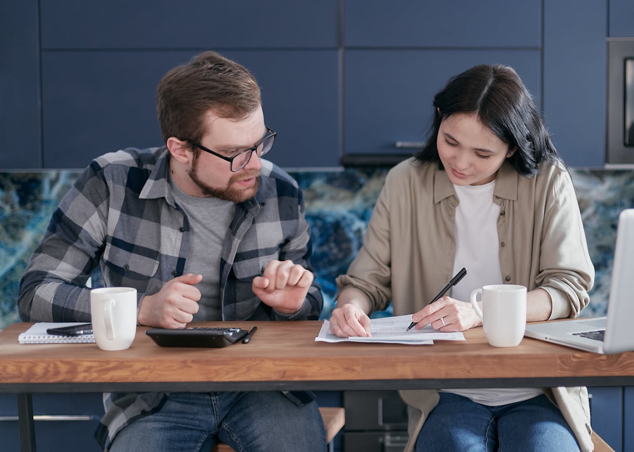 Couple at a table planning on purchasing real estate