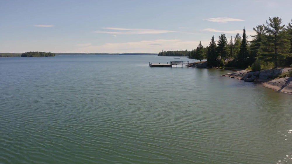 Calm lake and treed shoreline near Kingston