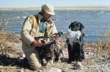 Hunter with his catch and his dog