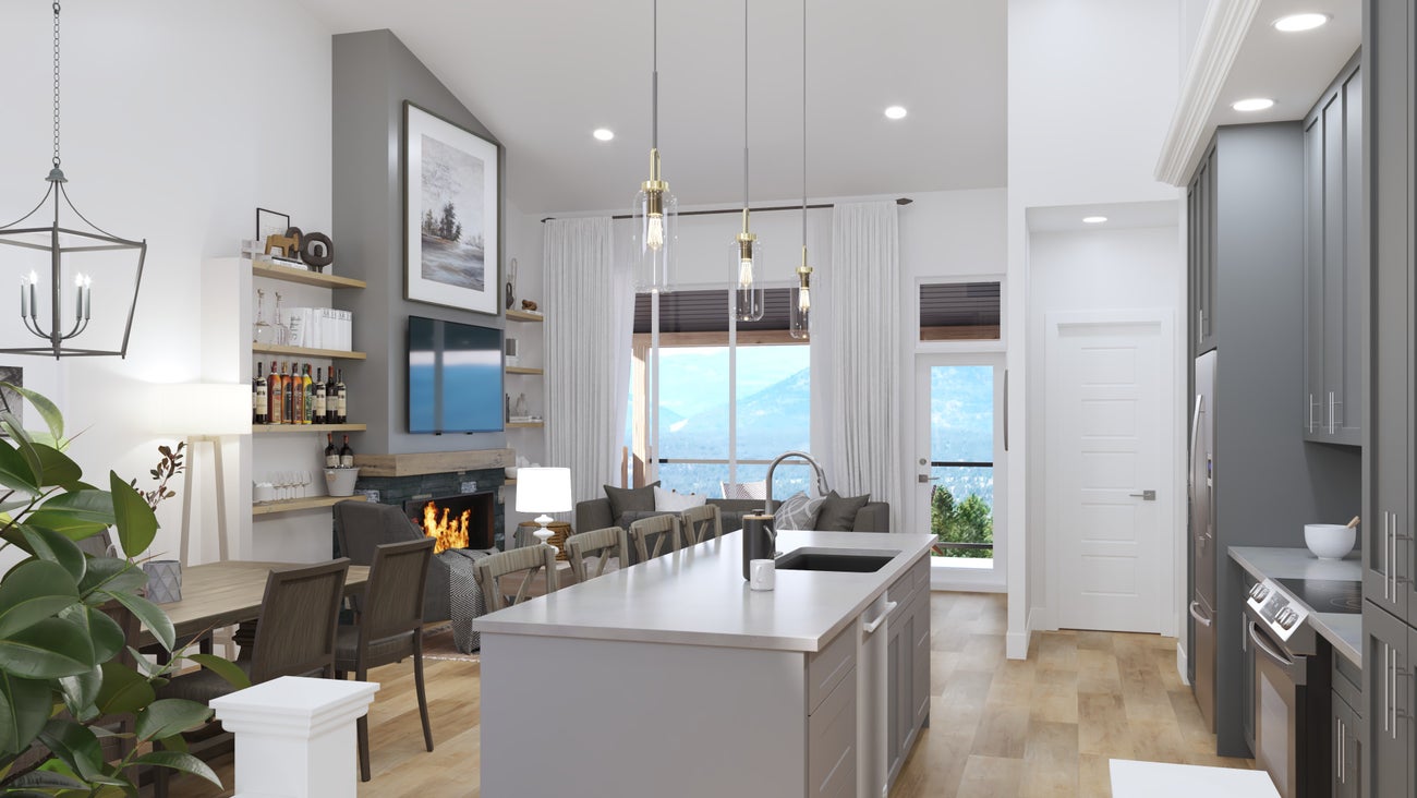 Elegant interior of a Fairmont townhome kitchen and dining area with modern decor, featuring high ceilings, pendant lighting, a stone fireplace, and a spacious island, complemented by a scenic mountain view through large windows
