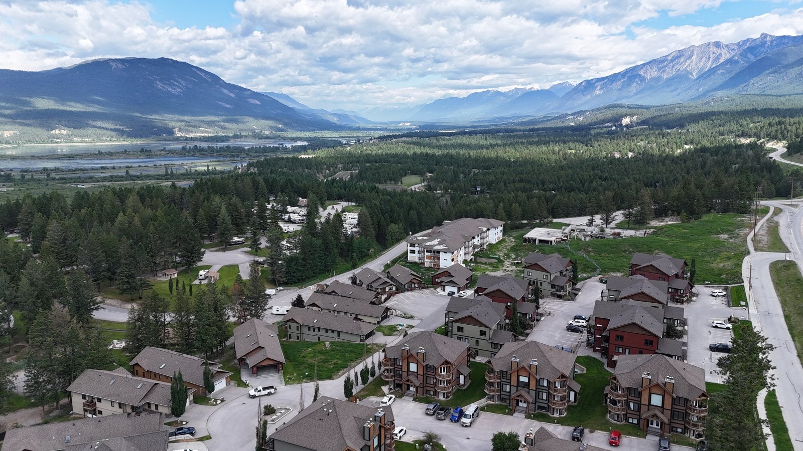 Aerial view of homes and townhomes in Radium Hot Springs, BC, with the Columbia Valley and Rocky Mountains beyond