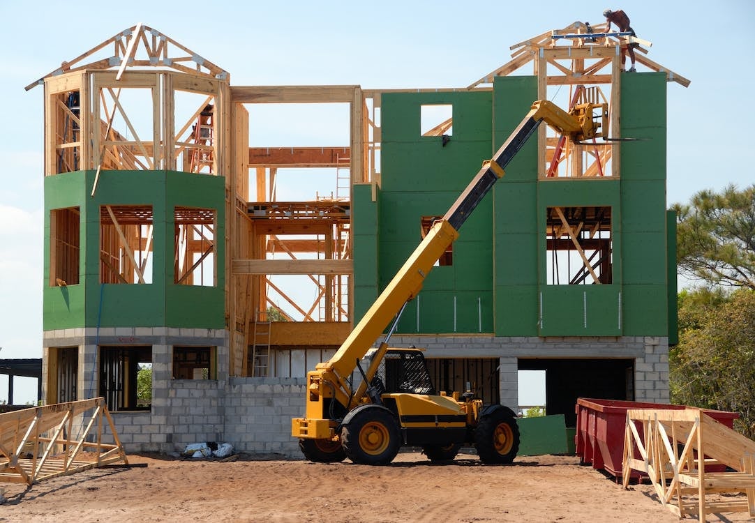 Heavy equipment moving materials for house under construction