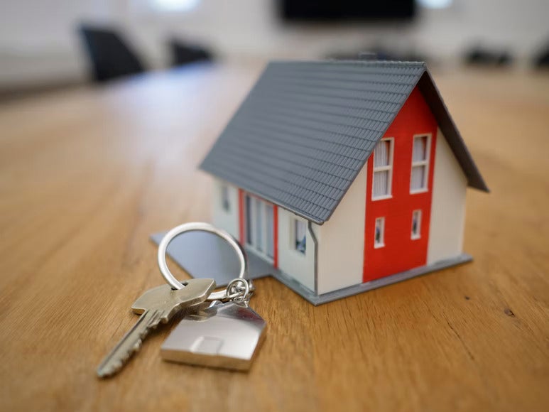 model house with key on table