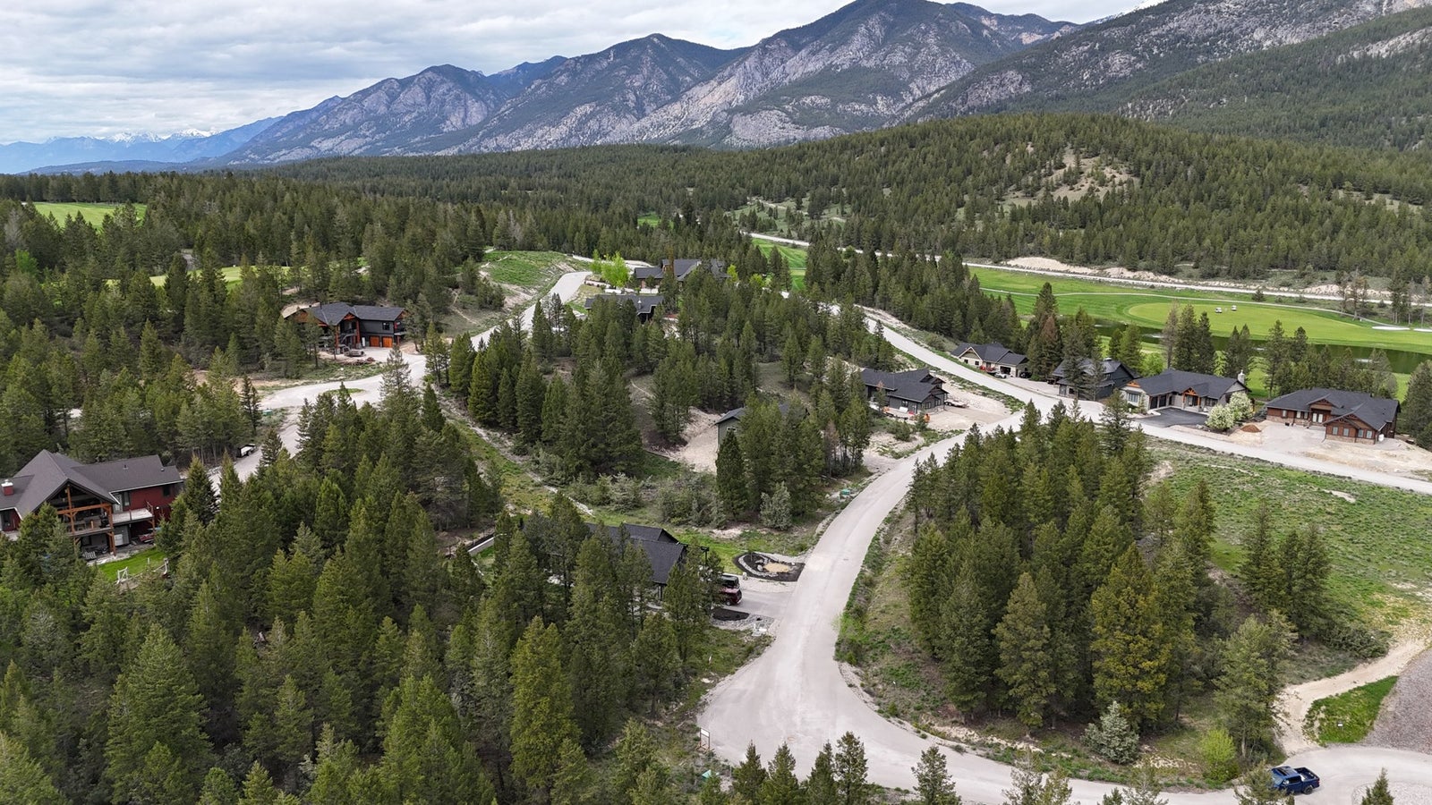 Copper Point estate homes along the golf course with the Rocky Mountains behind, near Invermere, BC