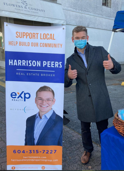 Harrison Peers Realtor posing with his sign in front of Bin 101 Harrison Peers Realtor posing with his sign in front of Bin 101