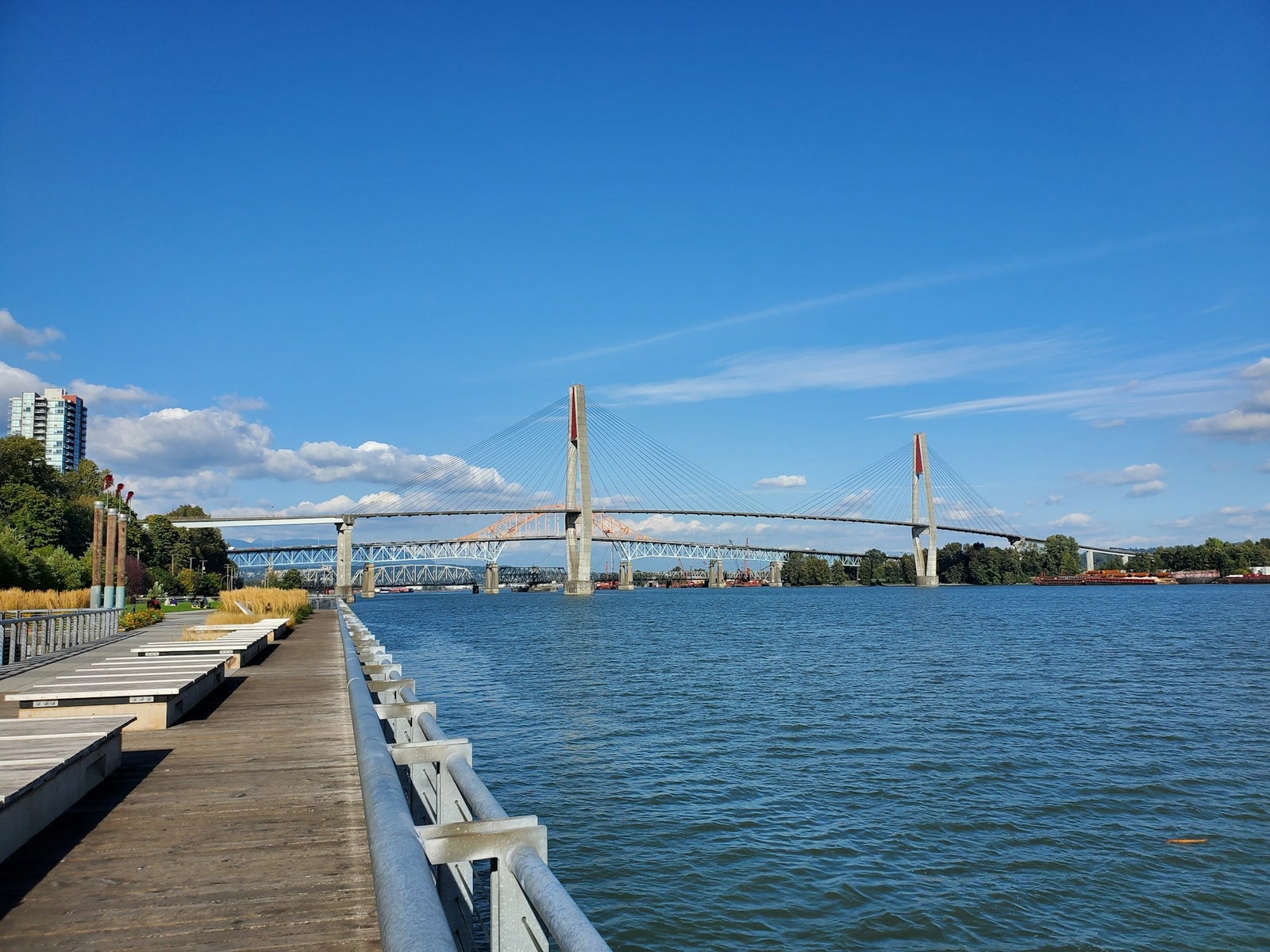 Fraser River Waterfront and Bridge | New Westminster, BC Fraser River with bridge and boardwalk in New Westminster, BC, showcasing the city’s waterfront and skyline.