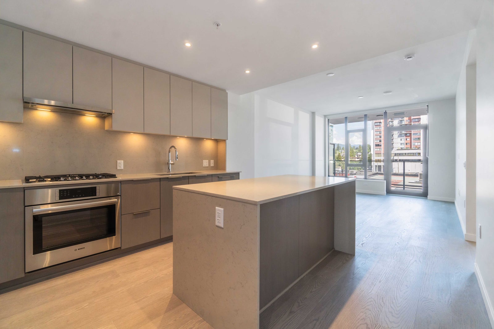 Modern kitchen in a North Vancouver rental condo with open living area and city views