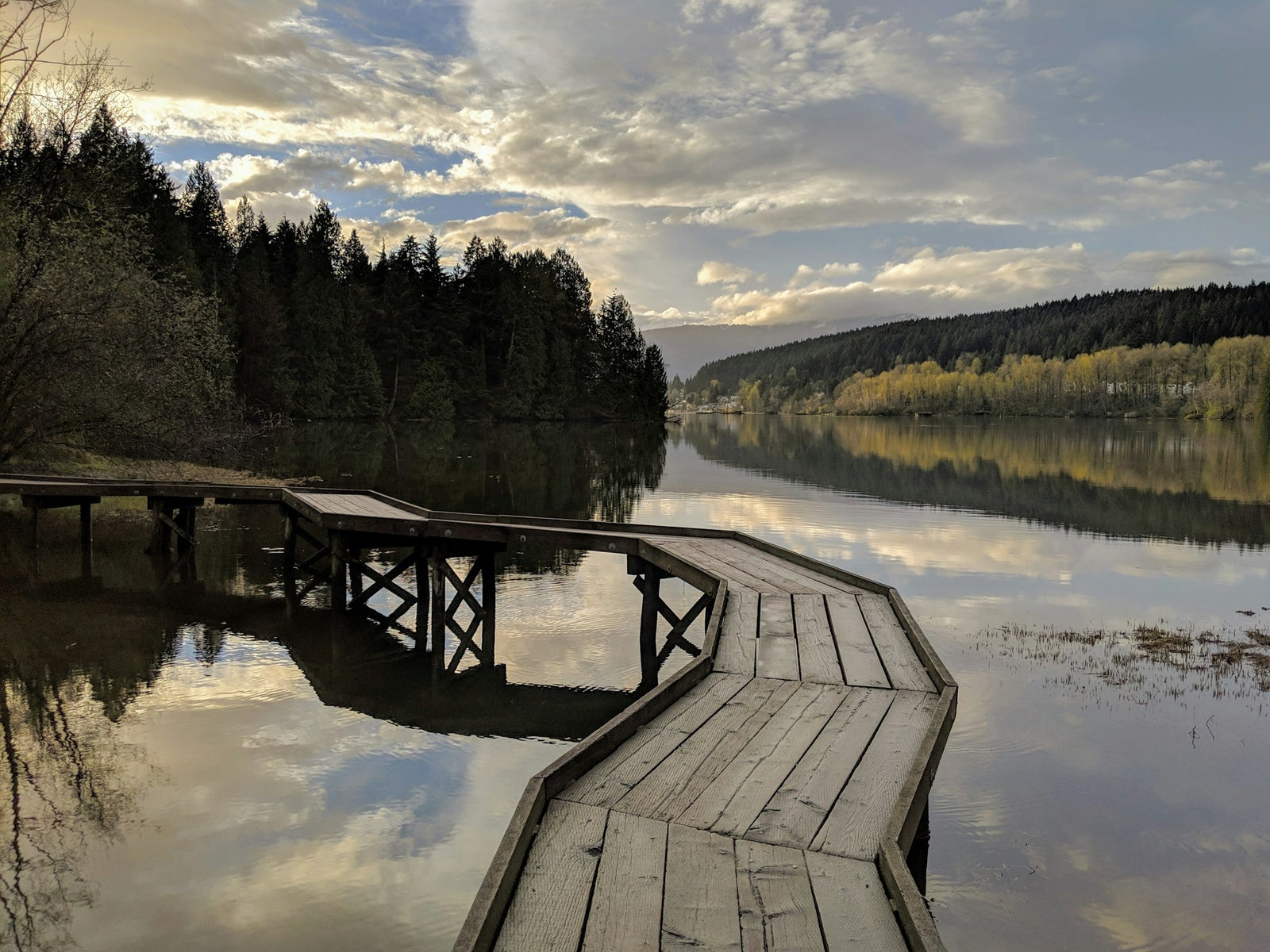 Wooden dock on Burrard Inlet in Port Moody BC at sunset — Port Moody rental market guide 2026