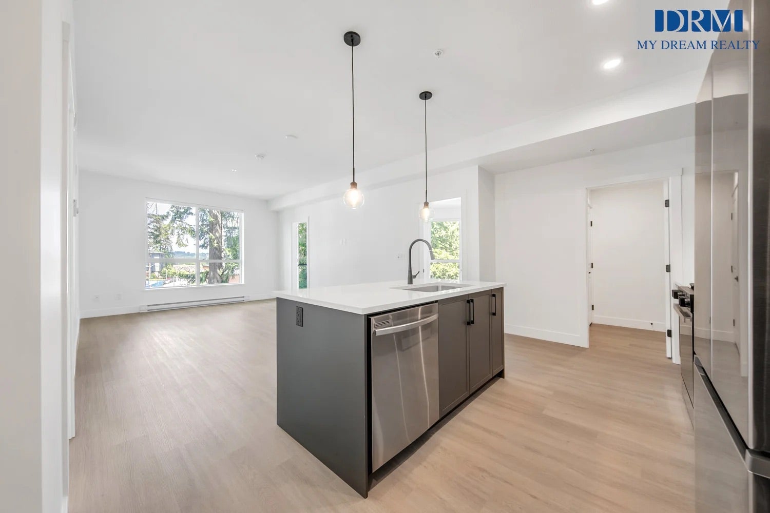 Modern kitchen and open living area in a West Vancouver rental property with treed views