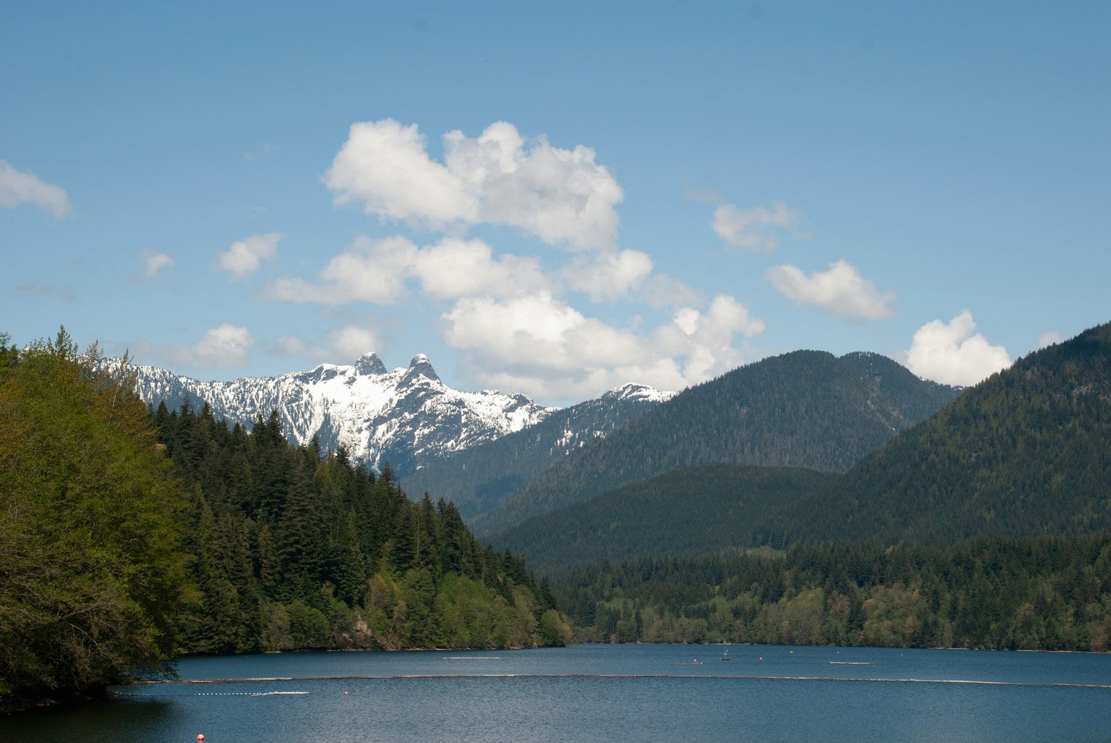 Snow-capped Lions mountain peaks above Capilano Lake in North Vancouver