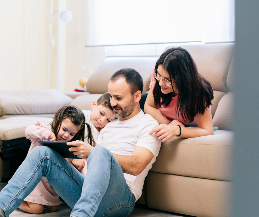 family with young child looking at tablet