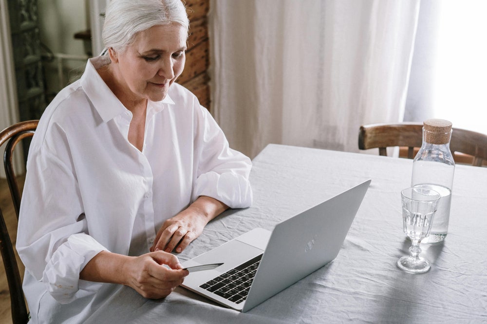 senior woman writing in notebook