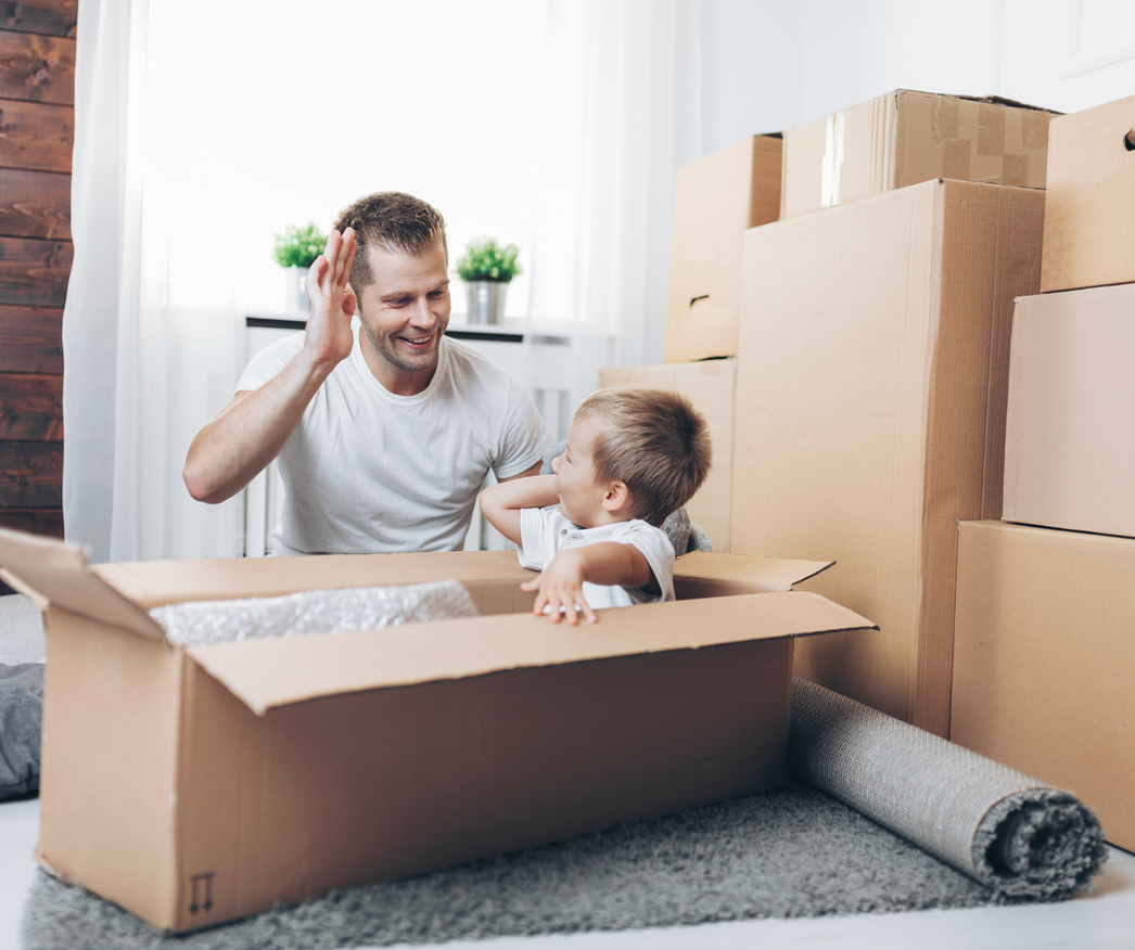 father and toddler packing for a move