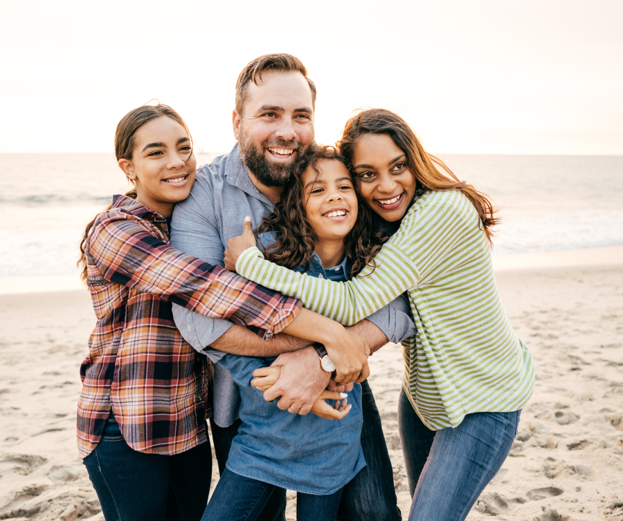 Mixed family photo on beach 