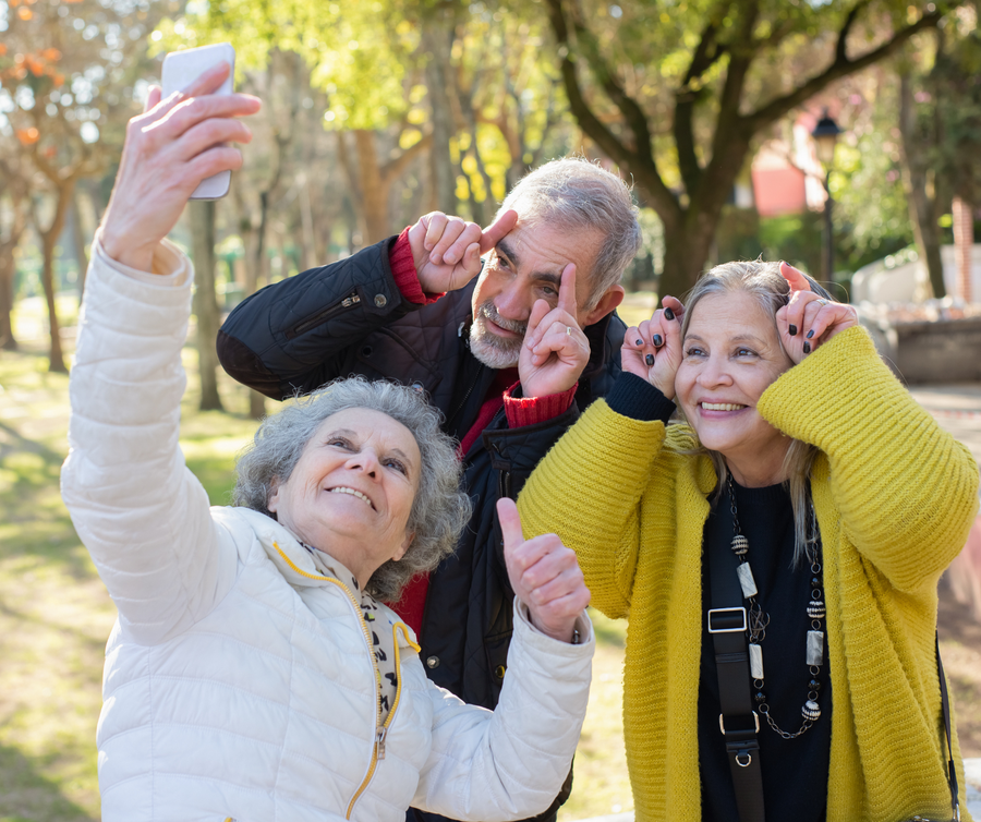 group of seniors taking a selfie in the park
