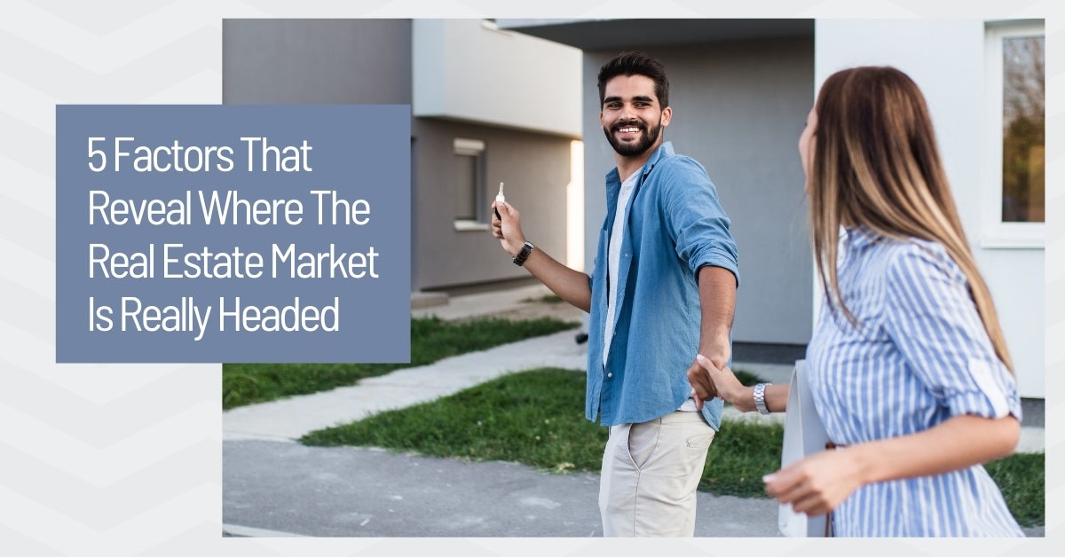 young homebuyer couple walking up to a house with a key in their hand